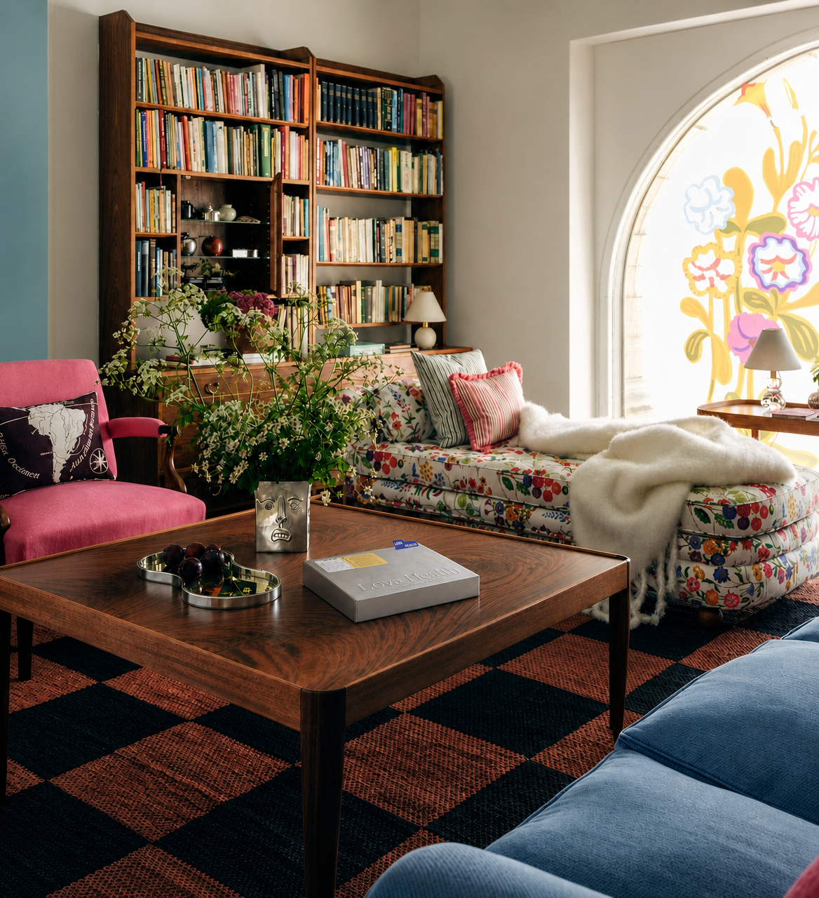 A Lova Health metallic box resting on a wooden coffee table in a sunlit, art-filled living room